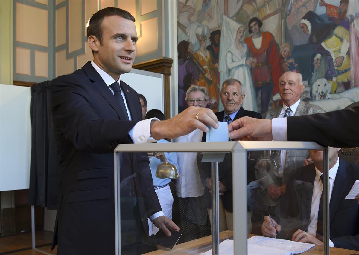 French President Emmanuel Macron casts his ballot as he votes at a polling station in Le Touquet, northern France, in the second round of the French parliamentary elections — Sunday, June 18, 2017. (Christophe Archambault/AP)