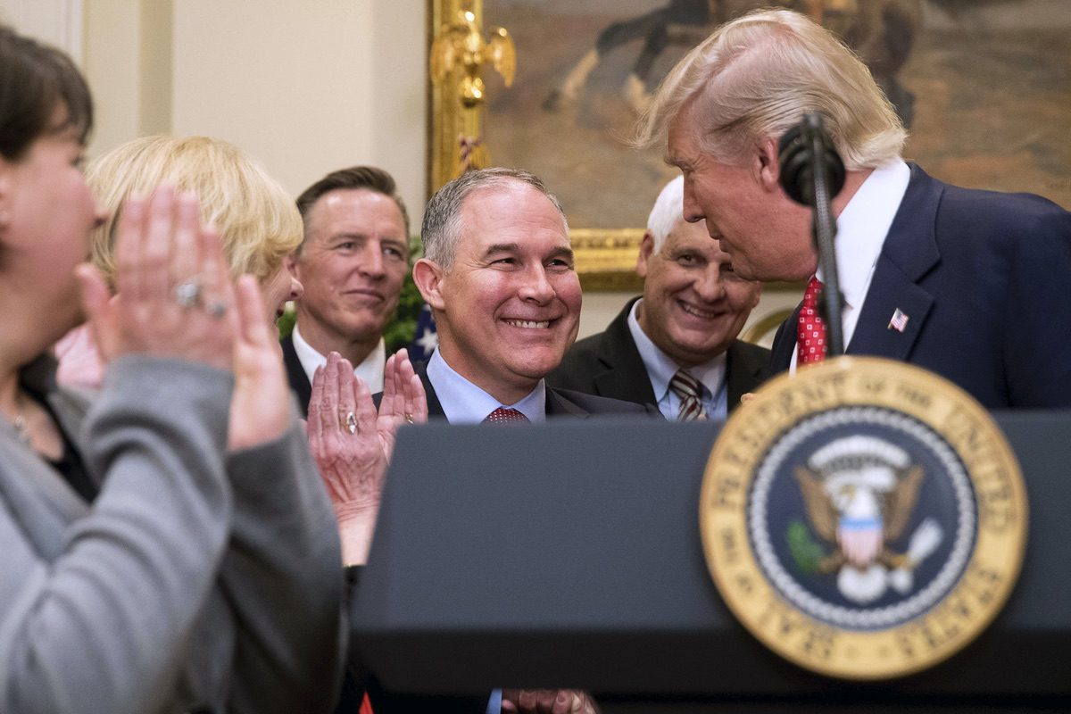 President Donald Trump, right, shakes hands with Environmental Protection Agency (EPA) Administrator Scott Pruitt, center, in the Roosevelt Room in the White House, Tuesday, Feb. 28, 2017. (AP Photo/Andrew Harnik)