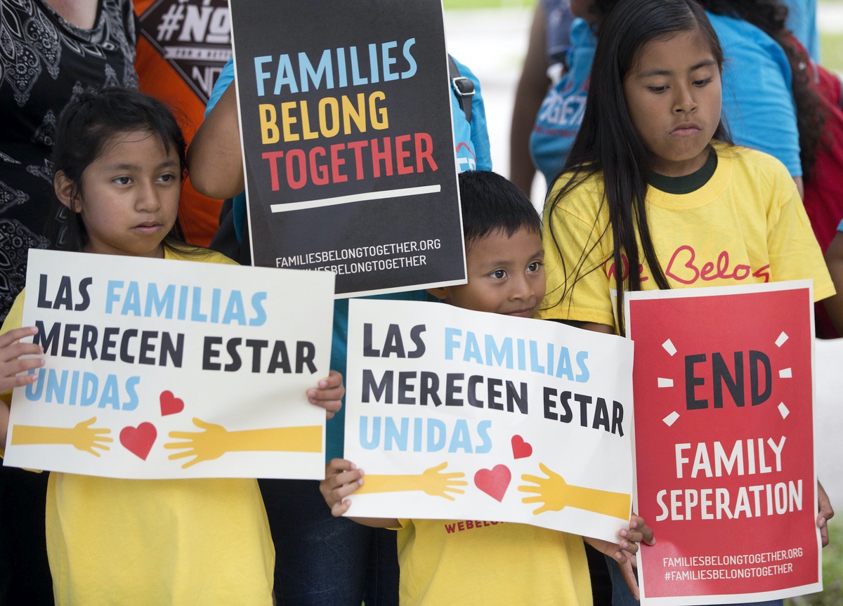 A group of children hold up signs during a demonstration in front of the Immigration and Customs Enforcement (ICE) offices, Friday, June 1, 2018, in Miramar, Fla. (AP Photo/Wilfredo Lee)