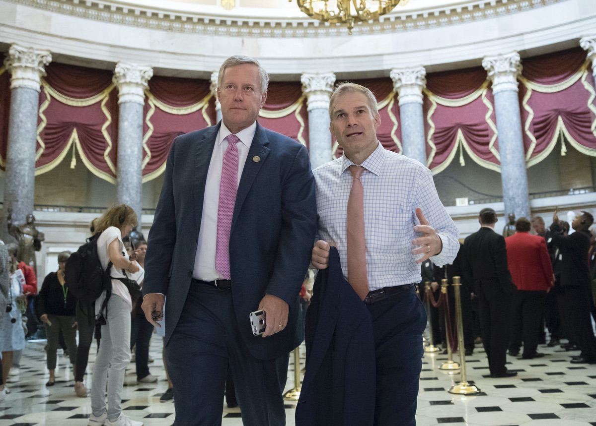Rep. Mark Meadows, R-N.C., chairman of the conservative House Freedom Caucus, and Rep. Jim Jordan, R-Ohio, a key member of the group, walk through Statuary Hall at the Capitol in Washington, Wednesday, Sept. 13, 2017. (AP Photo/J. Scott Applewhite)