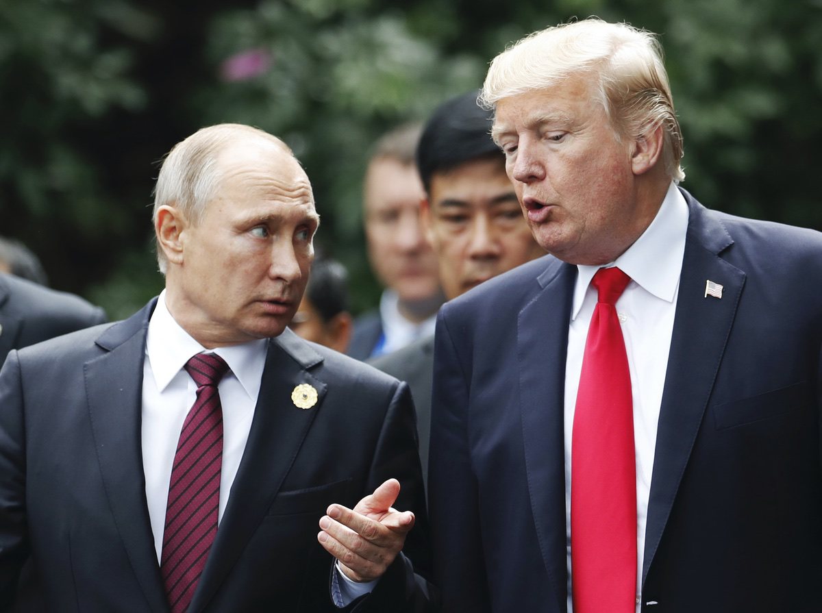 U.S. President Donald Trump and Russia’s President Vladimir Putin talk during the family photo session at the APEC Summit in Danang, Vietnam, Saturday, Nov. 11, 2017. (Jorge Silva/Pool Photo via AP)