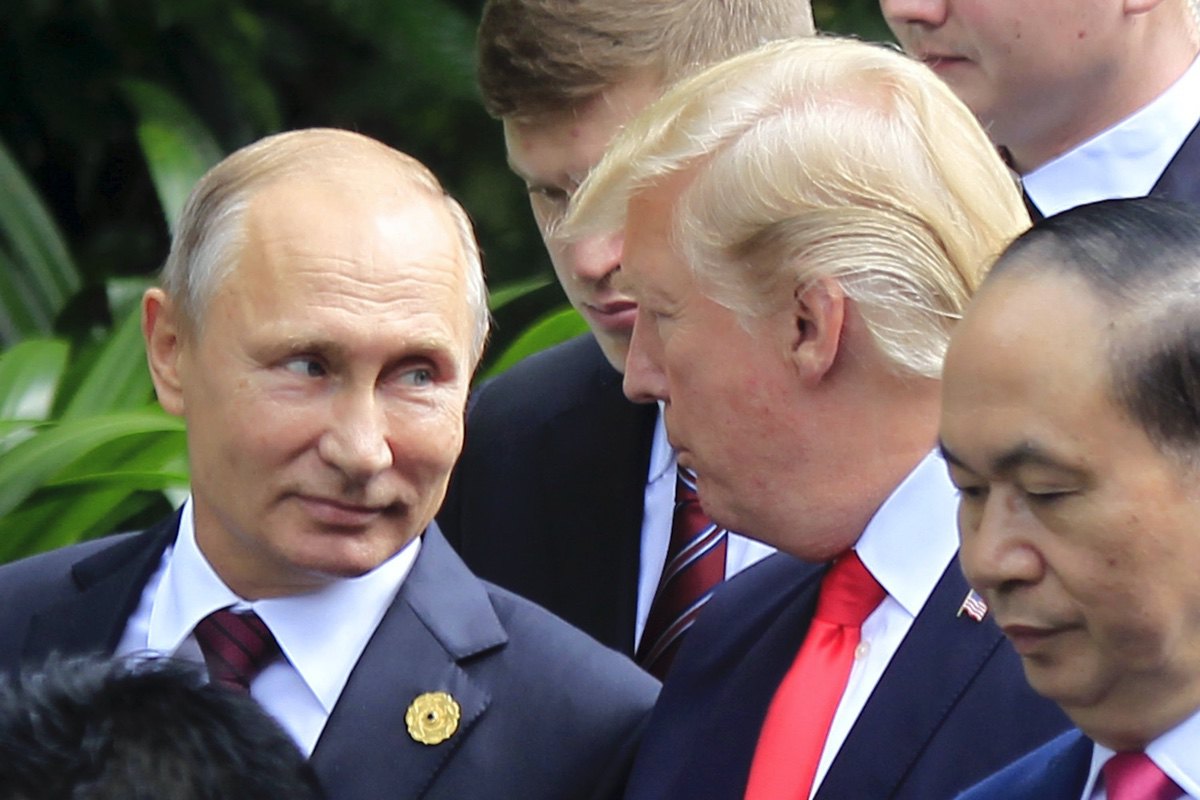 Russian President Vladimir Putin, left, and U.S. President Donald Trump talk as they arrive for the family photo session during the Asia-Pacific Economic Cooperation (APEC) Summit in Danang, Vietnam, Saturday, Nov. 11, 2017. (AP Photo/Hau Dinh)