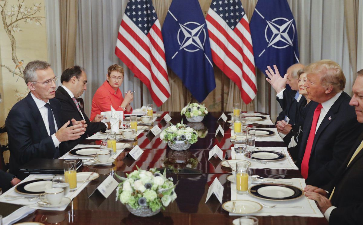 U.S. President Donald Trump, right, and NATO Secretary General Jens Stoltenberg, left, both gesture during their bilateral breakfast, Wednesday July 11, 2018 in Brussels, Belgium. (AP Photo/Pablo Martinez Monsivais)